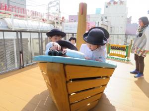 遊具「森の湖のボート」で遊ぶ幼稚園児