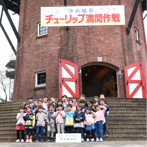 ゆめ風車の前で記念撮影をする園児たち